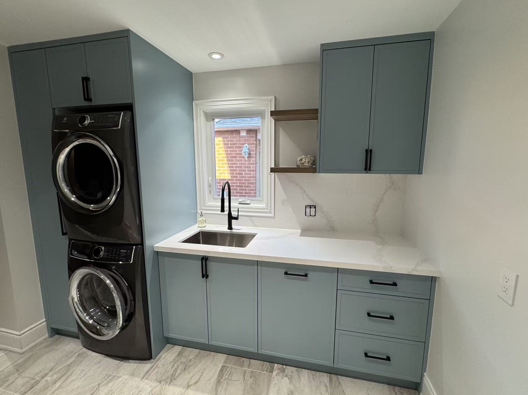 Teal laundry room cabinets