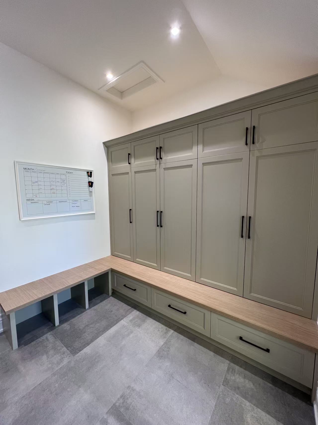Sage green mudroom with bench